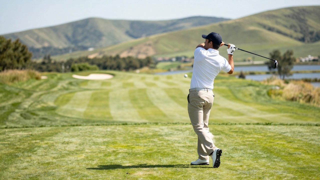 Golfer taking a powerful swing on a scenic, well-maintained golf course fairway